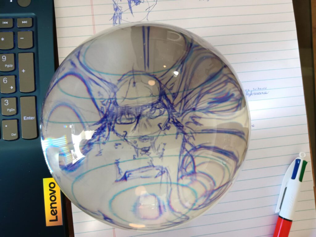 A picture of a glass orb over a drawing of Valla,   with stereoscopic vision this has a near 3D effect on the sketch.  